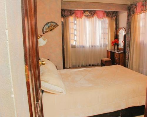 Een bed of bedden in een kamer bij Encantadora residencia en la mejor zona de la ciudad
