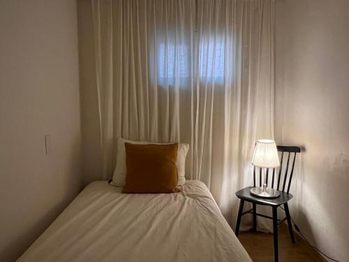 a bedroom with a bed with a lamp and a window at Stay Midcentury in Seoul