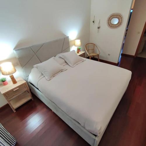 a bedroom with a large white bed and a table at Fátima-Ourém - Quinta da Luz - breakfast included in Ourém