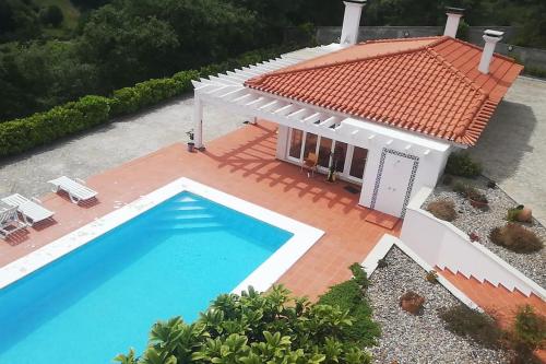 an aerial view of a house with a swimming pool at Fátima-Ourém - Quinta da Luz - breakfast included in Ourém