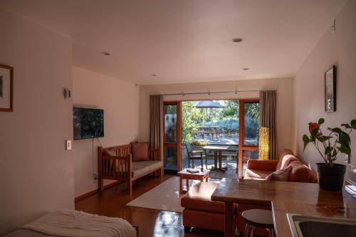 a living room with a couch and a table at Bow Street Studios - The Apartments in Raglan