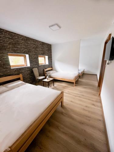 a bedroom with a bed and a couch and a chair at Etno domaćinstvo Dvožak in Pluzine