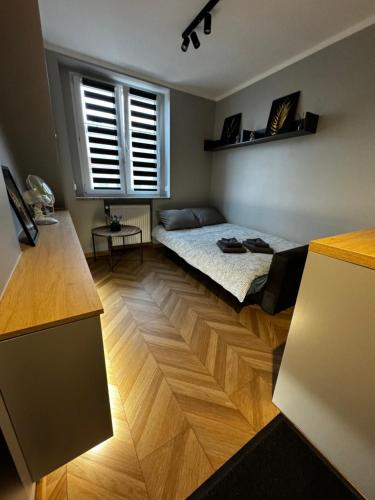 a room with a bed and a window in it at Studio przy Rynku - self check in in Opole