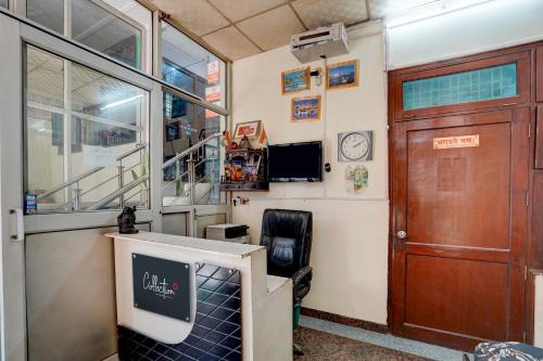 a room with a door and a tv and a door at Super OYO OM SAI RAM GUEST HOUSE in Gurgaon