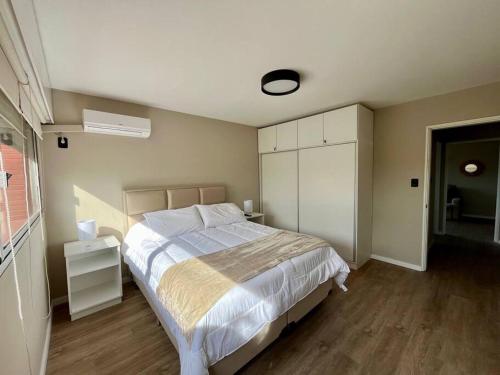 a bedroom with a large bed and a window at la vista in Colonia del Sacramento