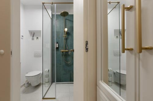 a bathroom with a glass shower and a toilet at 1910 Boutique Hotel in Braşov