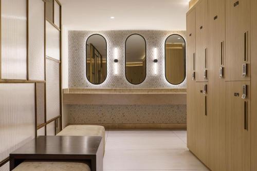 a dressing room with four mirrors and a table at Sheraton Abu Dhabi Hotel & Resort in Abu Dhabi