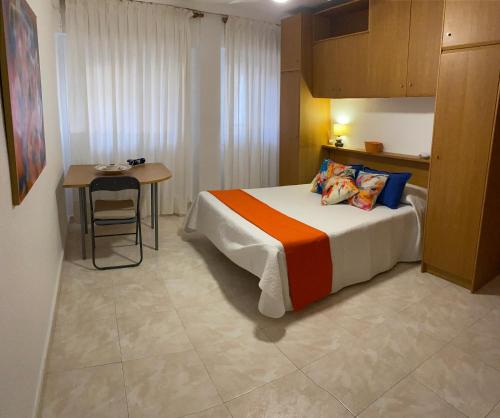 a hotel room with a bed and a table at Casa del Carmen in Lorca