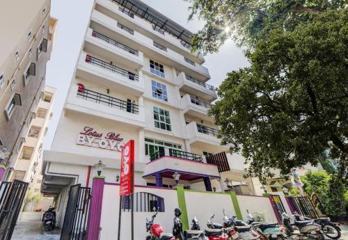 a building with motorcycles parked in front of it at Hotel O JNTU college Near LULU mall, KPHB Colony. in Hyderabad