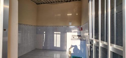 a bathroom with a shower stall and a window at Suíte aconchegante e completa! Entrada independente em nova Iguaçu in Nova Iguaçu