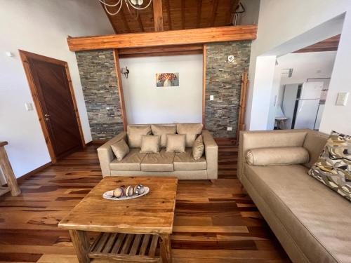 a living room with a couch and a table at Noreen Departamentos in San Martín de los Andes
