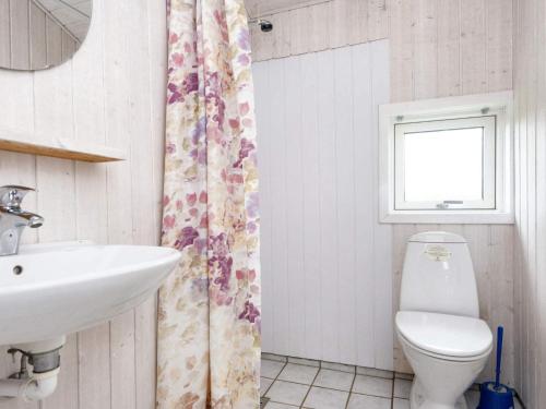 a bathroom with a sink and a toilet and a window at 9 person holiday home in Børkop-By Traum in Børkop