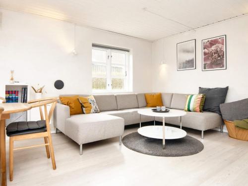 a living room with a couch and a table at 6 person holiday home in B rkop in Børkop