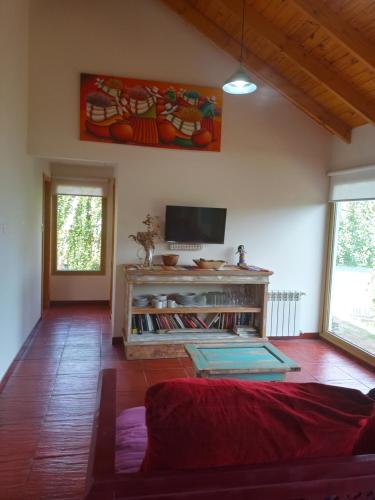 a living room with a couch and a flat screen tv at Doña Hilaria in El Calafate