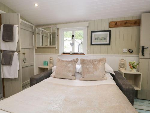 a bedroom with a large bed and a window at Woodmans Huts in Haverthwaite