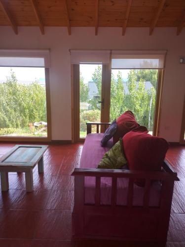 a dog laying on a couch in a living room at Doña Hilaria in El Calafate