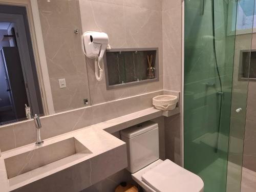 a bathroom with a sink and a toilet and a shower at Casa 6 Encanto dos Mares in Itajaí