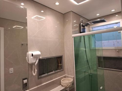a bathroom with a shower with a glass door at Casa 6 Encanto dos Mares in Itajaí