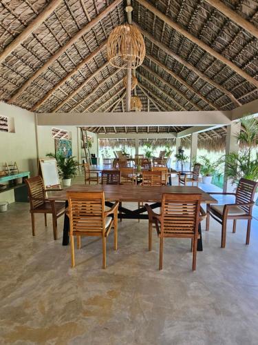 a dining room with a large wooden table and chairs at Margarita Ecovillage in Miches