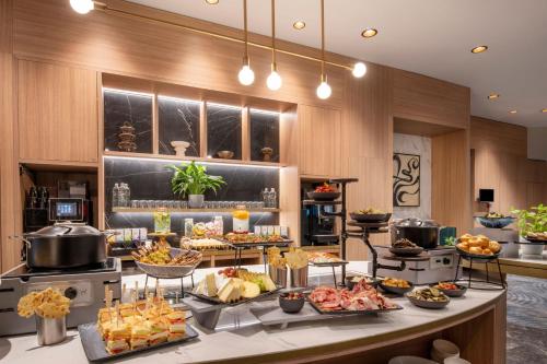 a buffet with many different types of food on a table at Brussels Marriott Hotel Grand Place in Brussels