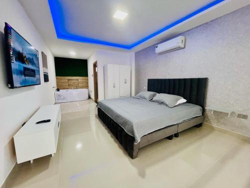 a bedroom with a bed with a blue ceiling at Vista Hills Loft & Jacuzzi in Guayaquil