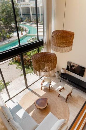 a living room with a view of a pool at villa bali: 3bd & priv pool in Tulum