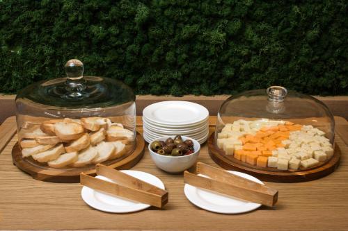a table topped with white plates and bowls of food at Element by Westin Orlando International Drive in Orlando