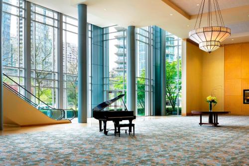 a grand piano in a lobby with windows at The Westin Bayshore, Vancouver in Vancouver