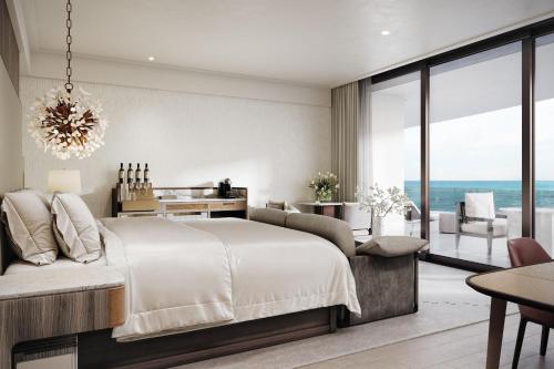 a bedroom with a large bed and a view of the ocean at The St Regis Longboat Key Resort in Longboat Key