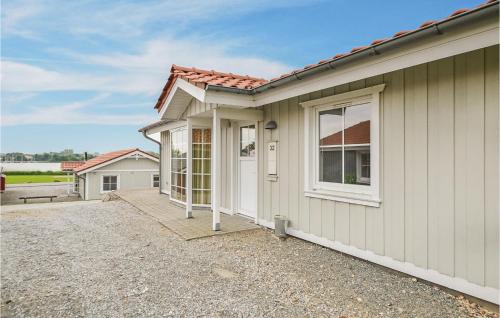 a house with a pathway leading to the front door at Marina Fiskenæs Feriepark in Gråsten
