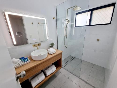 a bathroom with a sink and a shower at Holiday on Hibiscus in Urangan