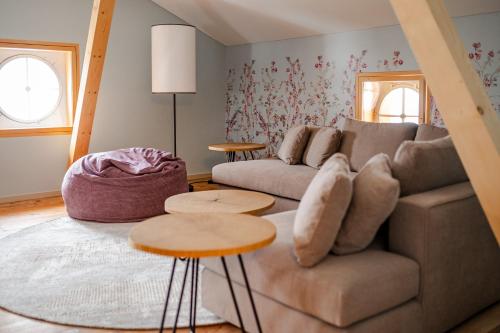 a living room with a couch and two tables at Villa Klainguti in Pontresina