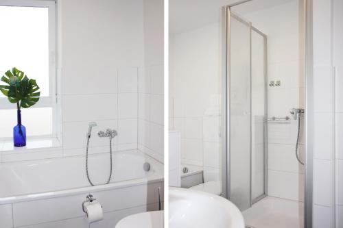 a white bathroom with a shower and a sink at fewo1846 - Ankerplatz I in Flensburg
