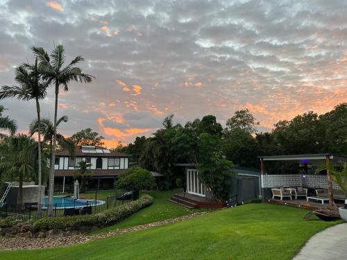 a house with a yard with a pool at Gold Coast Retreat in Ormeau