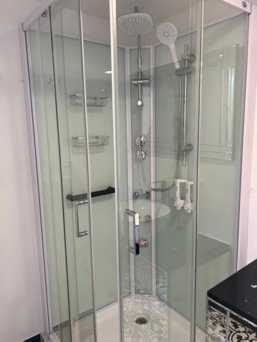 a shower with a glass door in a bathroom at Gold Coast Retreat in Ormeau