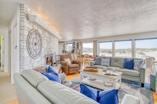 a living room with couches and a brick wall at Sand and Sky in Bayshore