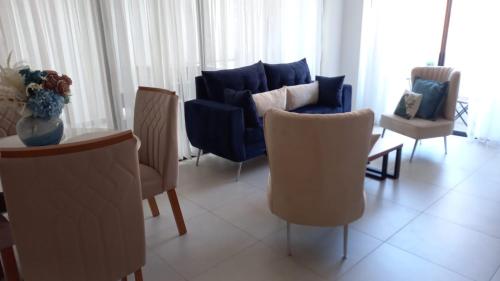 a living room with a blue couch and chairs at Brand new, with private Jacuzzi in Carlos Guerra