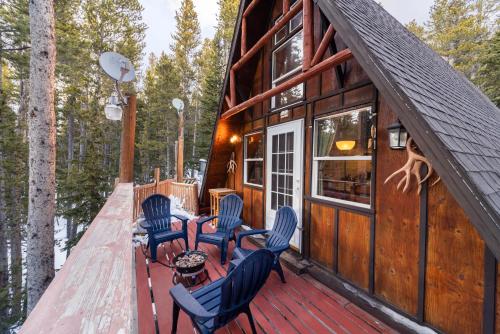 a deck of a cabin in the woods at A-Frame Cabin - Mountain Views, Deck, Pet Friendly in Idaho Springs