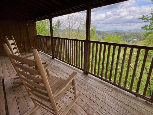 two rocking chairs sitting on a porch with a view at Dolly's # 1 condo in Sevierville