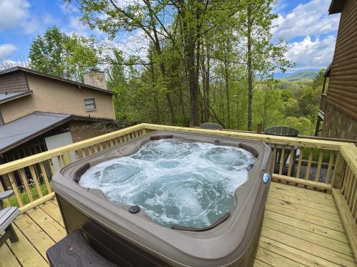 a hot tub on the deck of a house at Dolly's Lodge # 3 condo in Sevierville