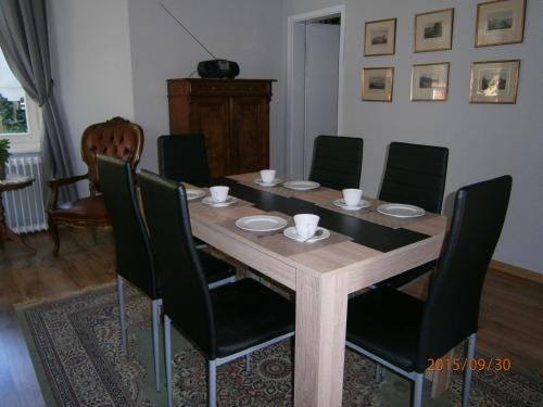 a dining room with a wooden table and chairs at Paul Lincke Residenz in Hahnenklee-Bockswiese