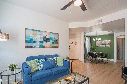 a living room with a blue couch and a table at Exclusive Unit Golf Side- Walkable Area - King Bed - N248 in Scottsdale