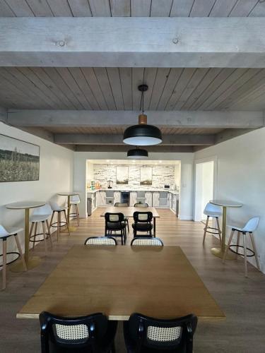 a dining room with a large wooden table and chairs at Prodigy Hotel, a Days Inn by Wyndham in Davis