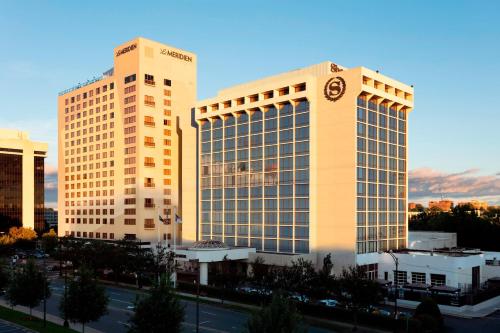 a large building with a clock on the side of it at Le Meridien Charlotte in Charlotte