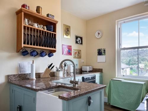 a kitchen with a sink and a window at Rock Terrace View in Bakewell