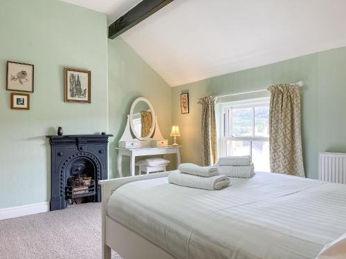 a bedroom with a bed with towels on it at Rock Terrace View in Bakewell