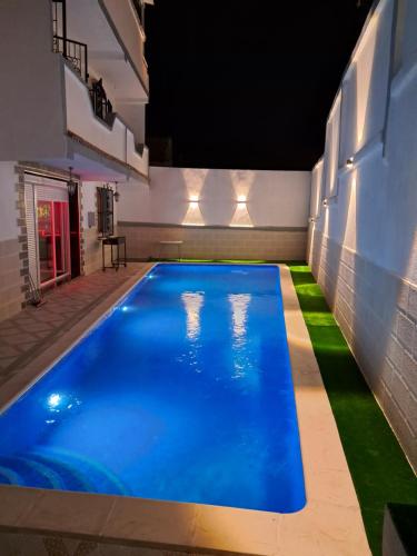 a swimming pool in the middle of a building at Villa belle vue in Boumaʼchouk