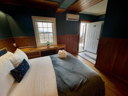 a bedroom with a large bed in a room with a window at Skyline Village Inn in Spruce Pine