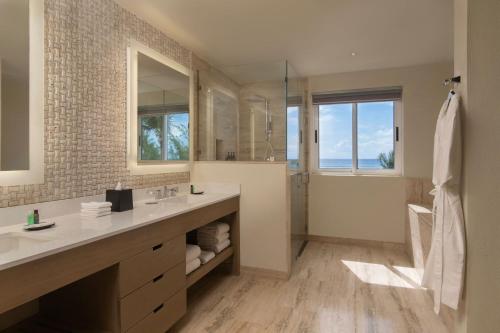a bathroom with a large sink and a shower at The Westin Puntacana Resort in Punta Cana