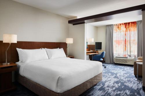 a hotel room with a large bed and a desk at Fairfield Inn & Suites by Marriott El Paso Airport in El Paso